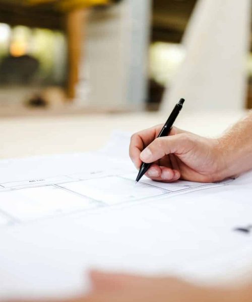 person writing on white paper